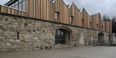 Serrated timber extension by 3+1 Architekti transforms stone barn into woodwork facility