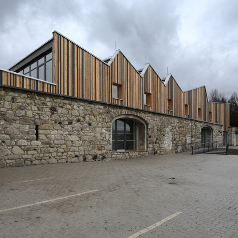Serrated timber extension by 3+1 Architekti transforms stone barn into woodwork facility