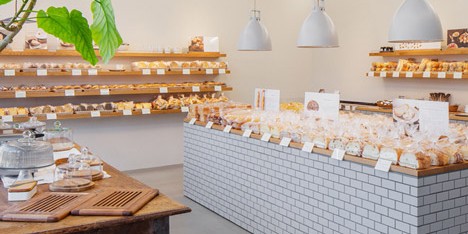 Style Bakery by SNARK features tiled walls and oak shelving