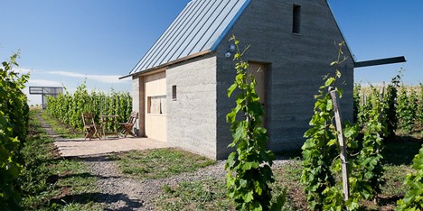 Earthy cabins hide amongst the vineyards at the Almagyar Wine Terrace in Hungary by by Péter Gereben and Balázs Marián