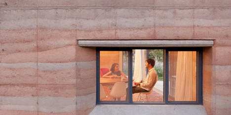 Rammed earth walls with striated patterns frame Tatiana Bilbao’s Ajijic House