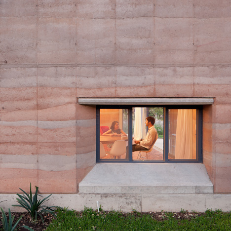 Rammed earth walls with striated patterns frame Tatiana Bilbao’s Ajijic House
