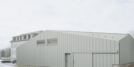 A faceted roof conceals the size of Hangar XS warehouse by Ecker Architekten