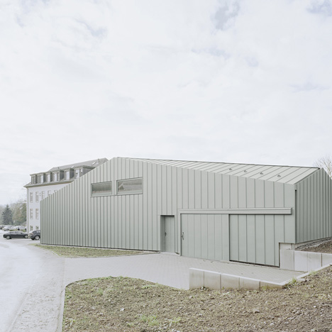 A faceted roof conceals the size of Hangar XS warehouse by Ecker Architekten