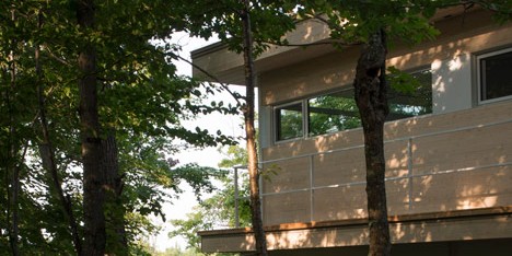 Atelier Pierre Thibault’s Le Grand Plateau house is raised on stilts above a forest floor