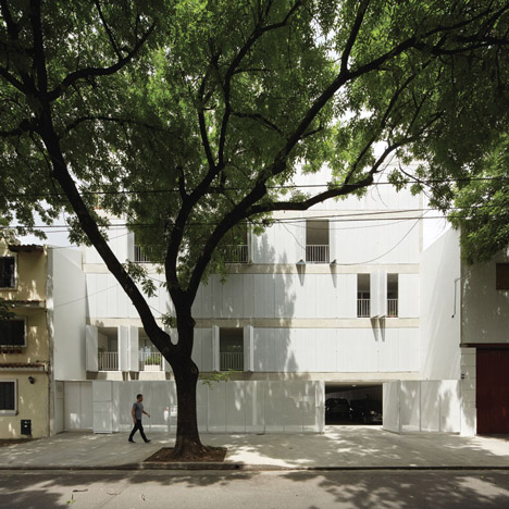 Perforated shutters fold back to reveal apartments at Sucre 4444 by Esteban-Tannenbaum