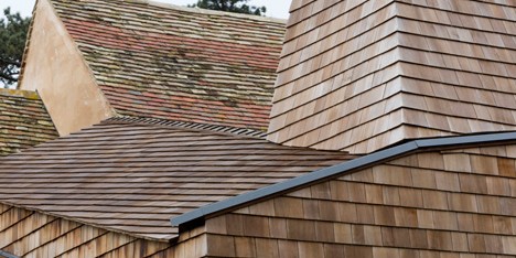 Wildfowl Cottage extension by 5th Studio is clad with shingles and raised over a flood plain