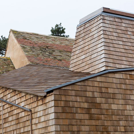 Wildfowl Cottage extension by 5th Studio is clad with shingles and raised over a flood plain