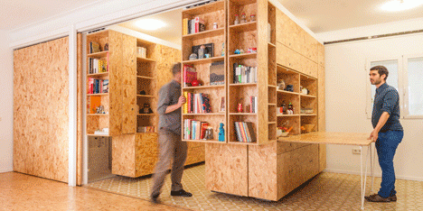 Sliding chipboard units create multifunctional  space in Madrid apartment