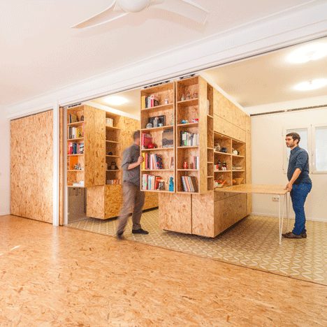 Sliding chipboard units create multifunctional  space in Madrid apartment