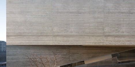 Matsuyama Architects builds concrete house on inclining site in Japanese housing estate