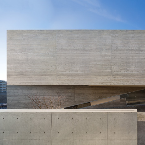 Matsuyama Architects builds concrete house on inclining site in Japanese housing estate