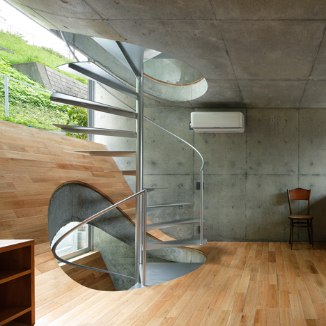 Spiral stairs puncture hilly floors inside Takeshi Hosaka’s House in Byobugaura