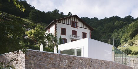 Mining museum by V2S contrasts a traditional stone wall with a metal box