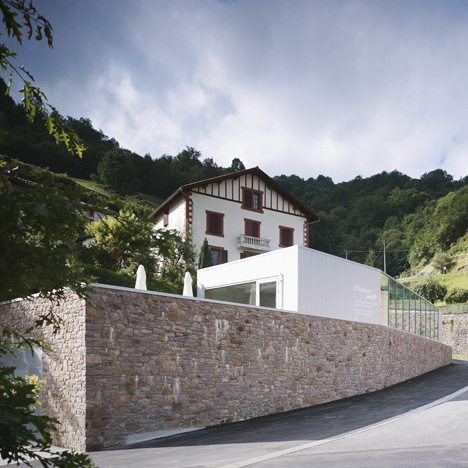 Mining museum by V2S contrasts a traditional stone wall with a metal box