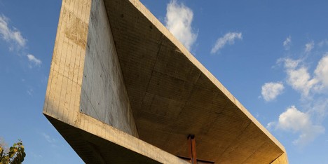 Skewed concrete chapel by EMC Arquitectura balances over a mountainside in El Salvador