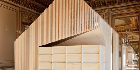 Wooden meeting rooms by Estelle Vincent include seating, lockers and a slide