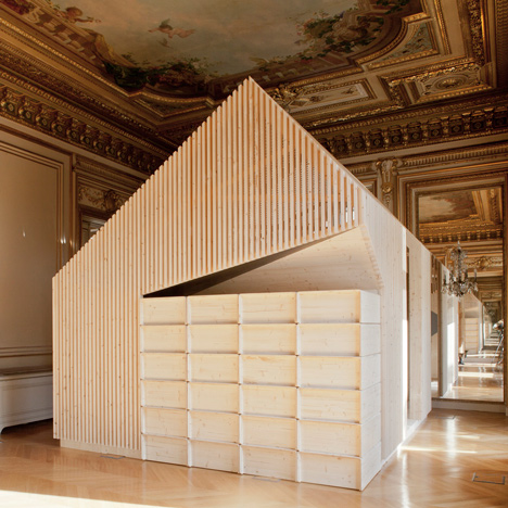 Wooden meeting rooms by Estelle Vincent include seating, lockers and a slide