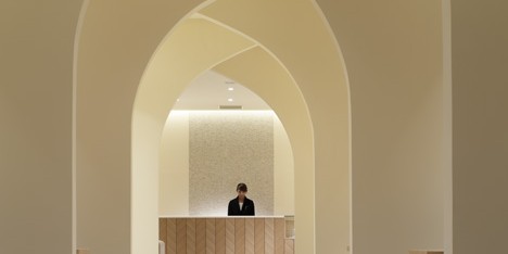 Curving walls create arched avenue through wedding planning venue by Ryo Matsui Architects