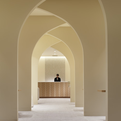 Curving walls create arched avenue through wedding planning venue by Ryo Matsui Architects