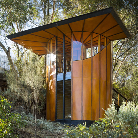 A tube of striped orange wood encloses Max Pritchard’s treetop studio