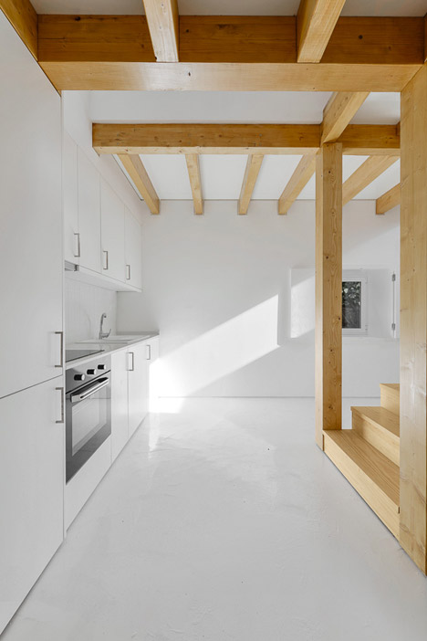 Wood Structure Inside Stone Walls by Corpo Atelier
