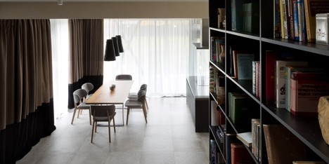 Ukraine house by Sergey Makhno combines a staircase with a two-storey-high bookcase