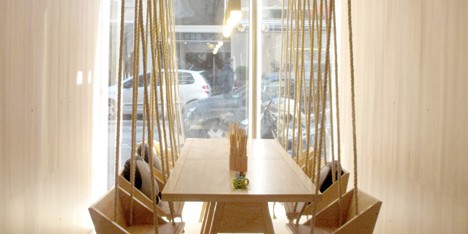 Fiii Fun House cafe by Íris Cantante features wooden swing seats