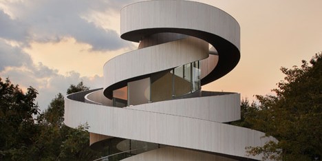 Intertwining staircases spiral around the glazed core of Hiroshi Nakamura’s Ribbon Chapel