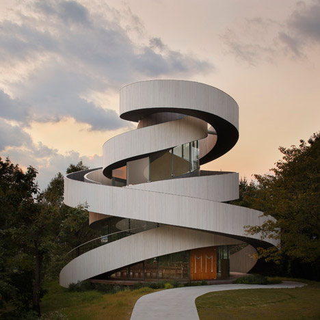 Intertwining staircases spiral around the glazed core of Hiroshi Nakamura’s Ribbon Chapel