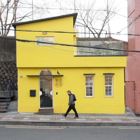 Seoul fashion boutique features yellow walls and an Eames bird above the entrance