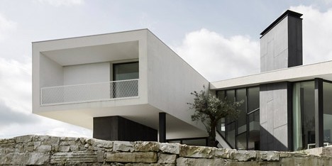 Vidigal House by Contaminar has a V-shaped plan enclosing a triangular garden