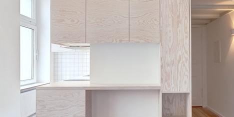 Pale wooden unit frames rooms and creates a new floor inside a Berlin micro-apartment