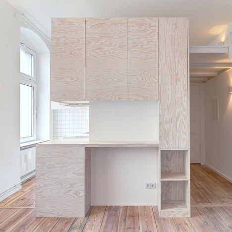 Pale wooden unit frames rooms and creates a new floor inside a Berlin micro-apartment