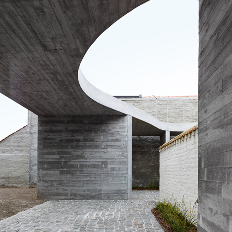 Concrete canopy creates two-storey terrace for home and clinic by Graux & Baeyens