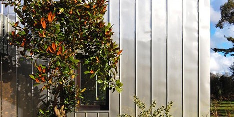 Edgley Design wraps a dilapidated 1960s house in stainless steel roofing