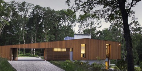 Bridge House by Joeb Moore & Partners straddles a site on the edge of a valley