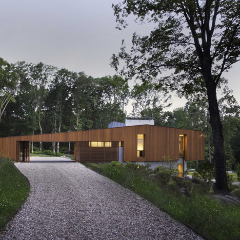 Bridge House by Joeb Moore & Partners straddles a site on the edge of a valley