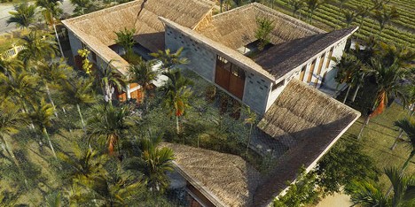 Cam Thanh Community House in Vietnam features thatched roofing and secluded courtyards
