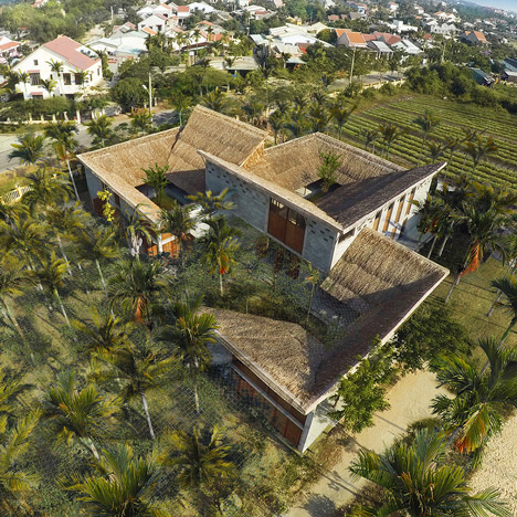 Cam Thanh Community House in Vietnam features thatched roofing and secluded courtyards