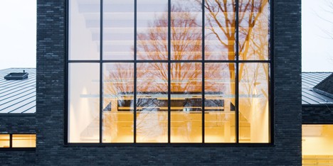 Omgeving’s black brick library in Zoersel is subdivided into smaller blocks