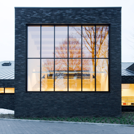 Omgeving’s black brick library in Zoersel is subdivided into smaller blocks