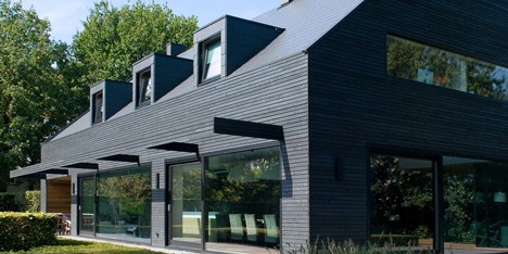House in the Netherlands upgraded with a dark grey cladding of timber panels and tiles
