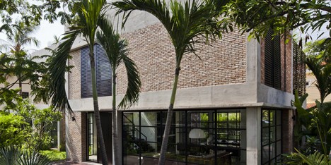 MM++ Architects replaces the old walls of a Vietnam house with red bricks and pivoting glass