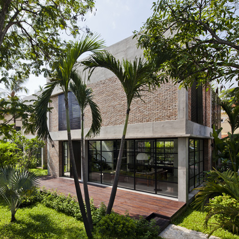 MM++ Architects replaces the old walls of a Vietnam house with red bricks and pivoting glass