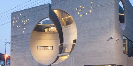 Concave facades on twin buildings by Moon Hoon create moon-shaped indents