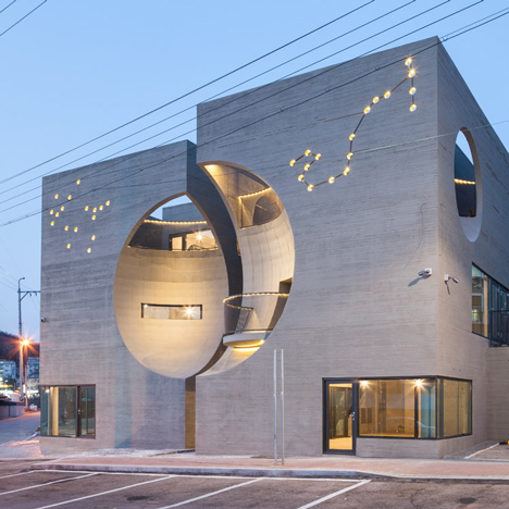 Concave facades on twin buildings by Moon Hoon create moon-shaped indents