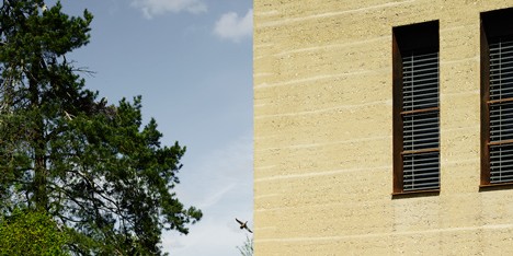 MLZD’s lakeside bird-watching centre features rammed earth walls and an aviary