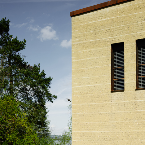 MLZD’s lakeside bird-watching centre features rammed earth walls and an aviary