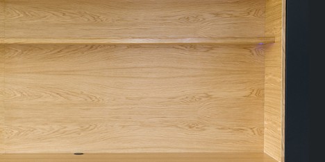 Wooden niches contain work surfaces and storage inside Black Line Apartment by Arhitektura d.o.o.